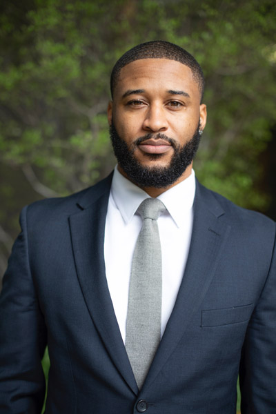 Man standing in blue suit and tie