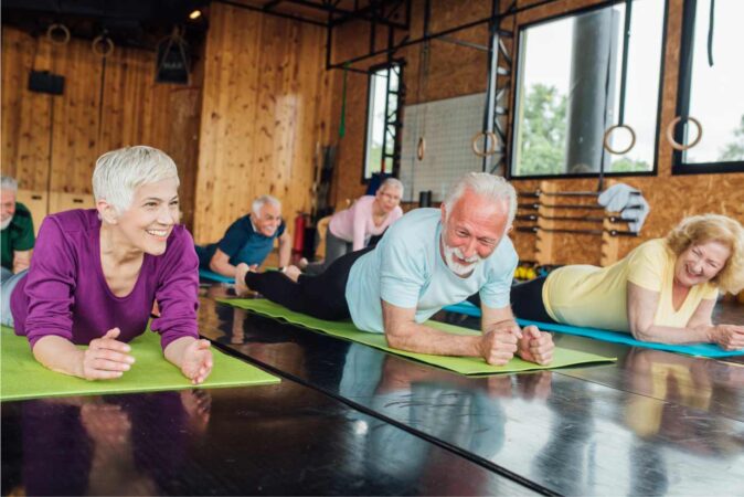 Seniors smiling while doing yoga